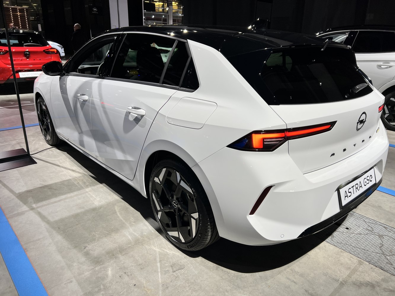 Rear and side view of a hatchback with distinctive taillights and two-tone roof.
