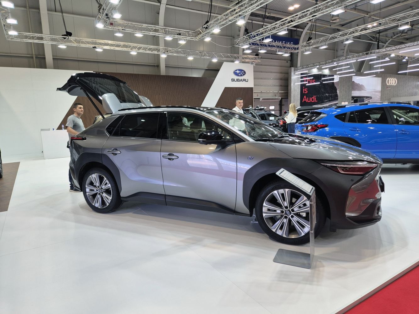 Side profile of electric SUV with open rear hatch