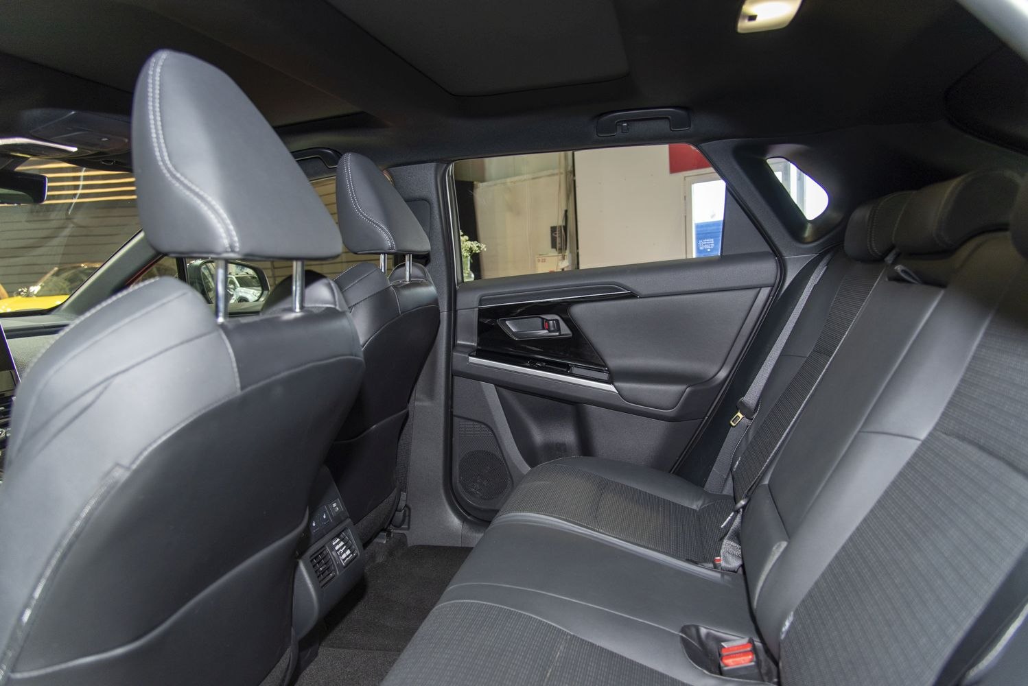 Rear seating area with black upholstery and door panel.