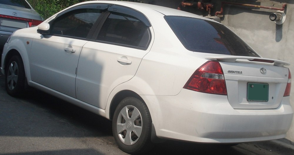 Rear side profile of sedan with spoiler and tinted windows