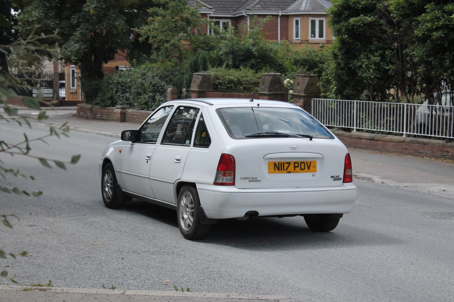 Rear view of a compact 5-door hatchback with a clean, classic design.