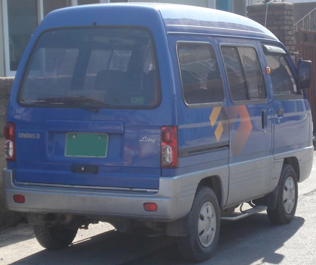 Compact blue van rear with sliding door and vertical taillights