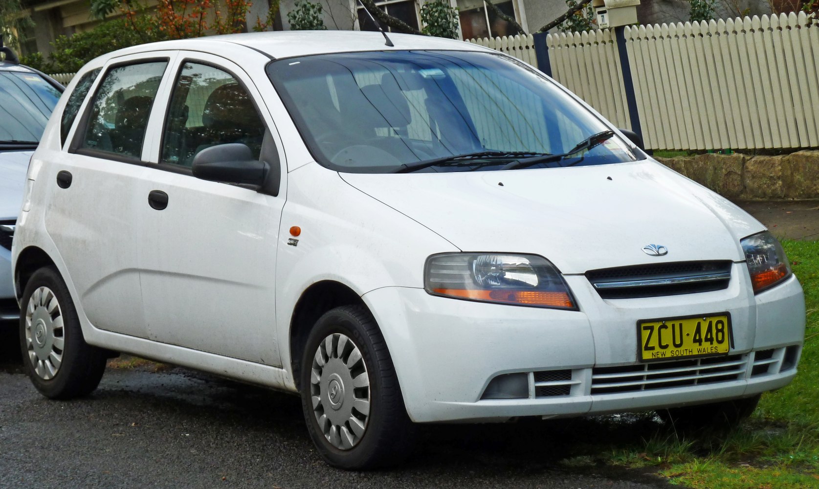 Front side view with distinctive headlights and compact hatchback design