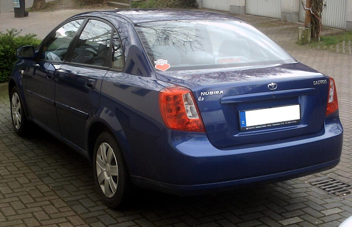 Rear and side view of a blue four-door sedan with distinctive taillights