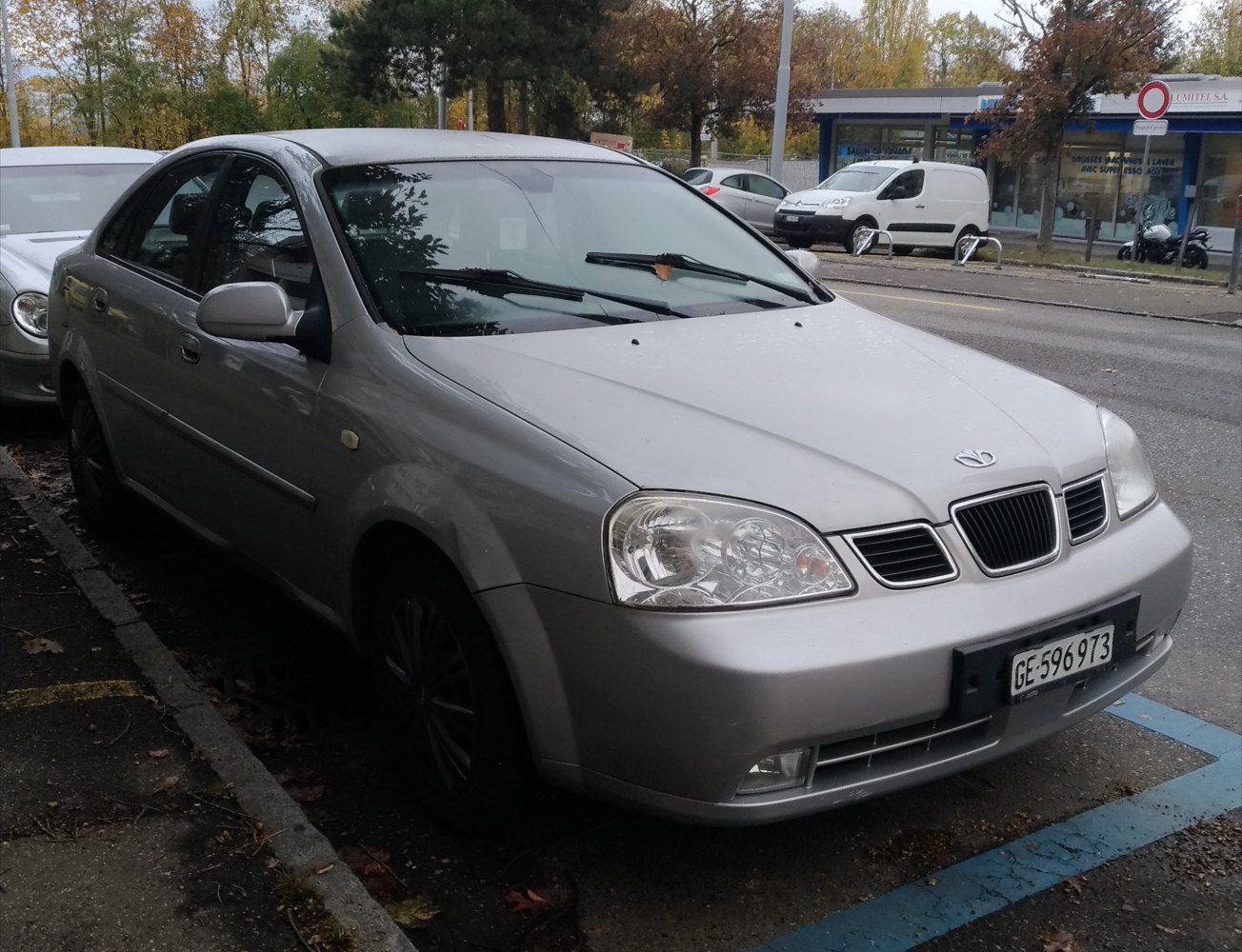 Silver sedan front angle showing headlights and grille