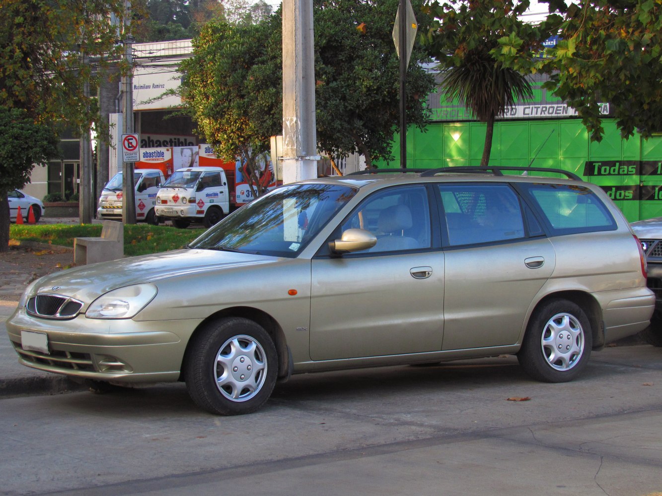 Side view of a mid-size station wagon with roof rails and alloy wheels.