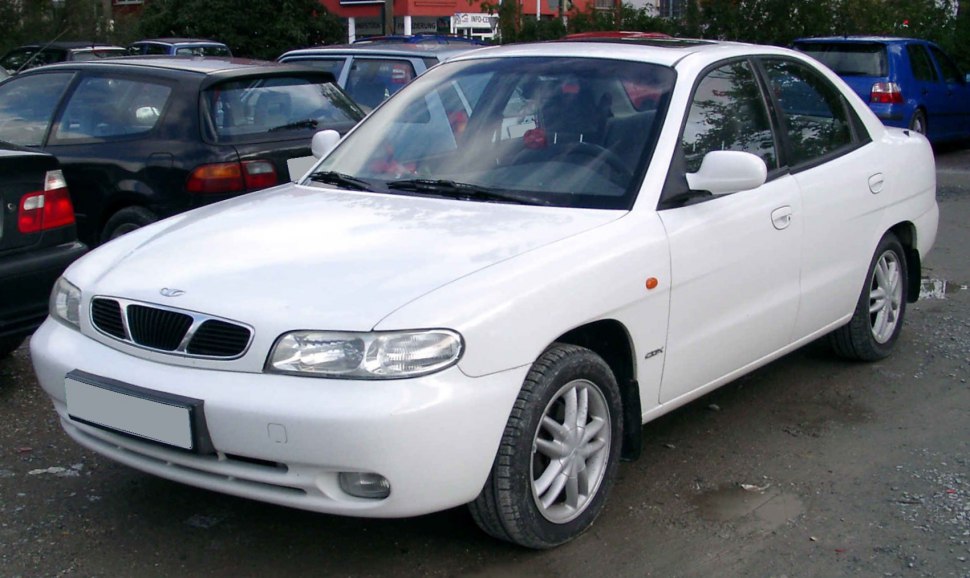 White four-door sedan shown from front-side angle