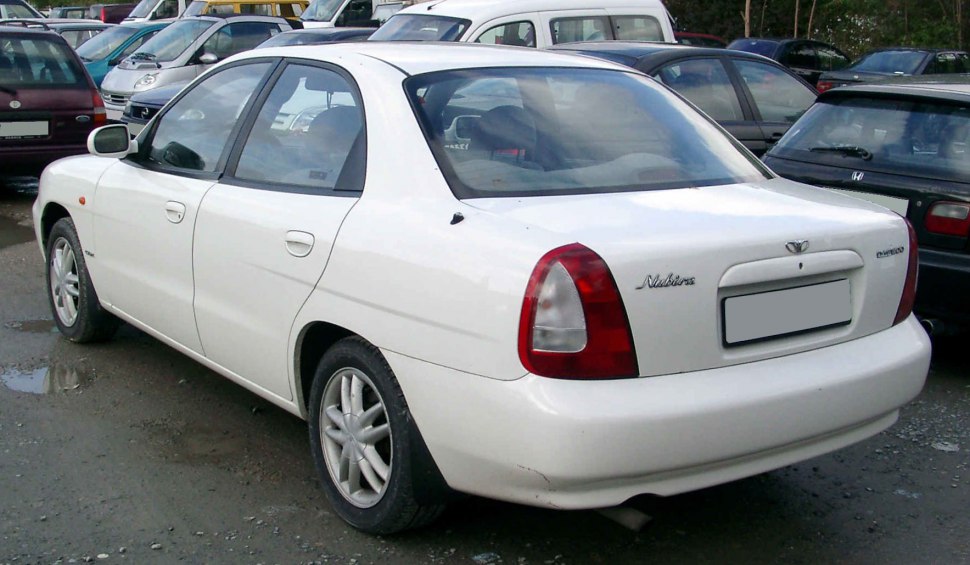 White mid-size sedan rear and side view with red rear lights