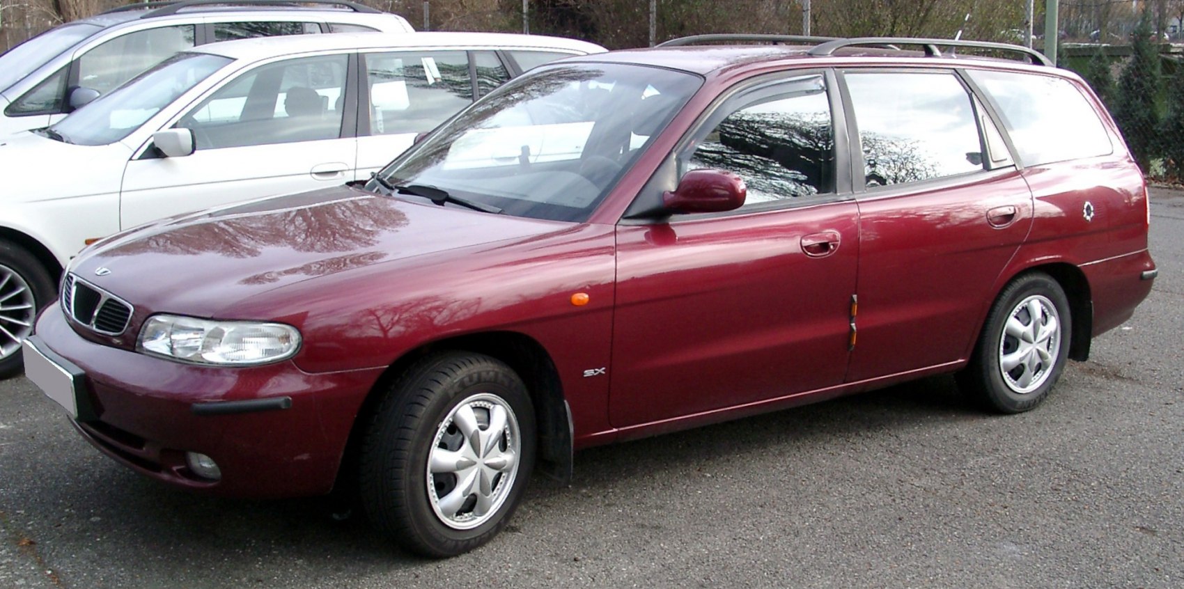 Maroon station wagon with classic 1990s design, roof rails, and five-door layout