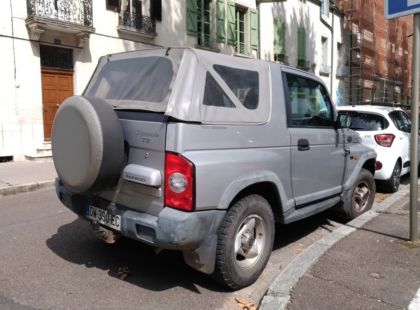 Rear view of soft top roof and spare wheel on compact SUV