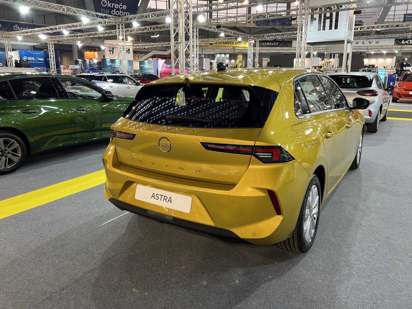 Metallic yellow hatchback rear with sleek tail lights and modern design