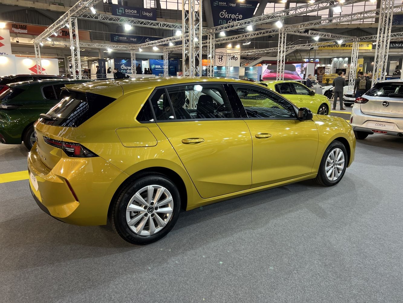 Yellow five-door hatchback with sharp taillights and aerodynamic shape