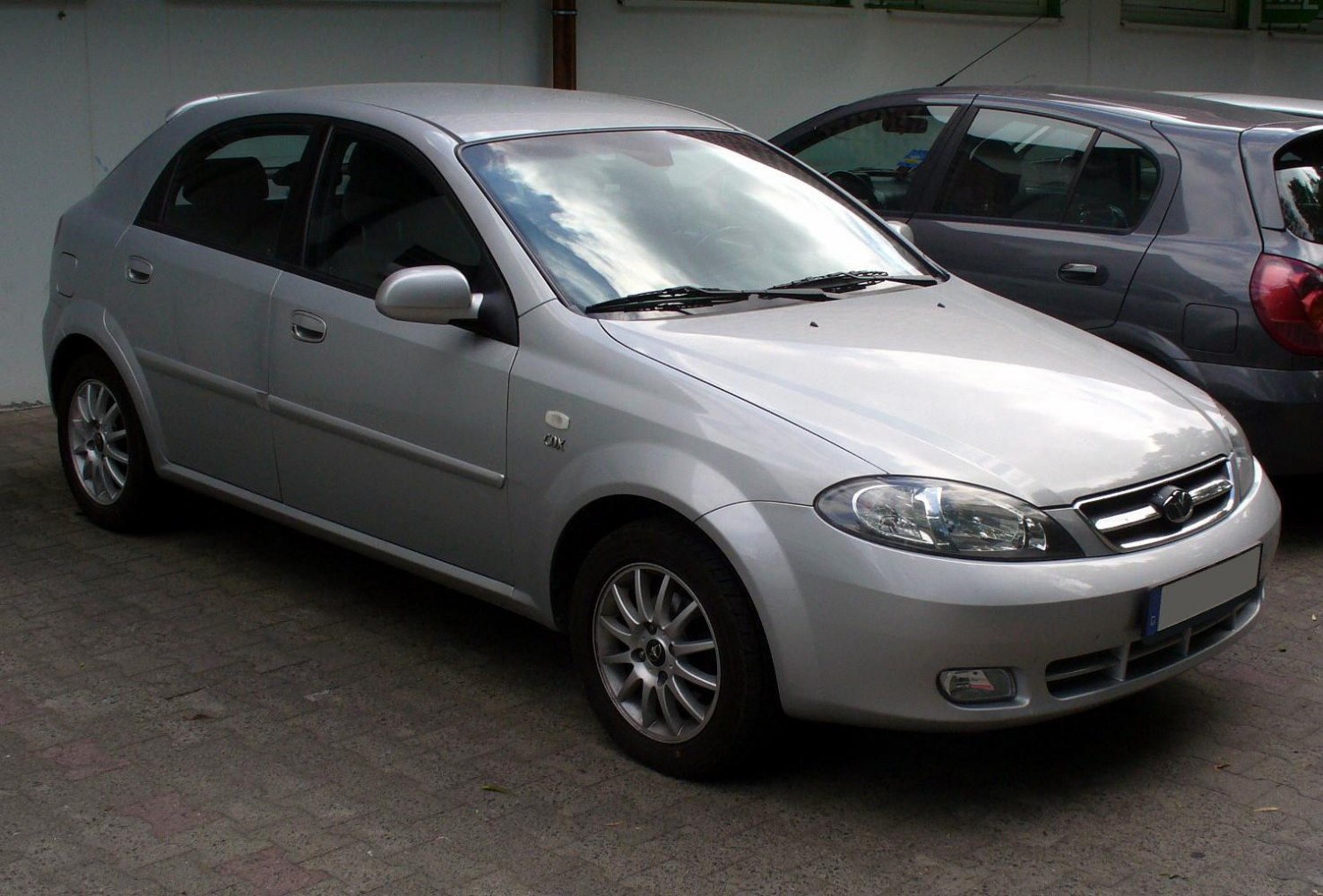 Silver compact hatchback with alloy wheels and front fog lights