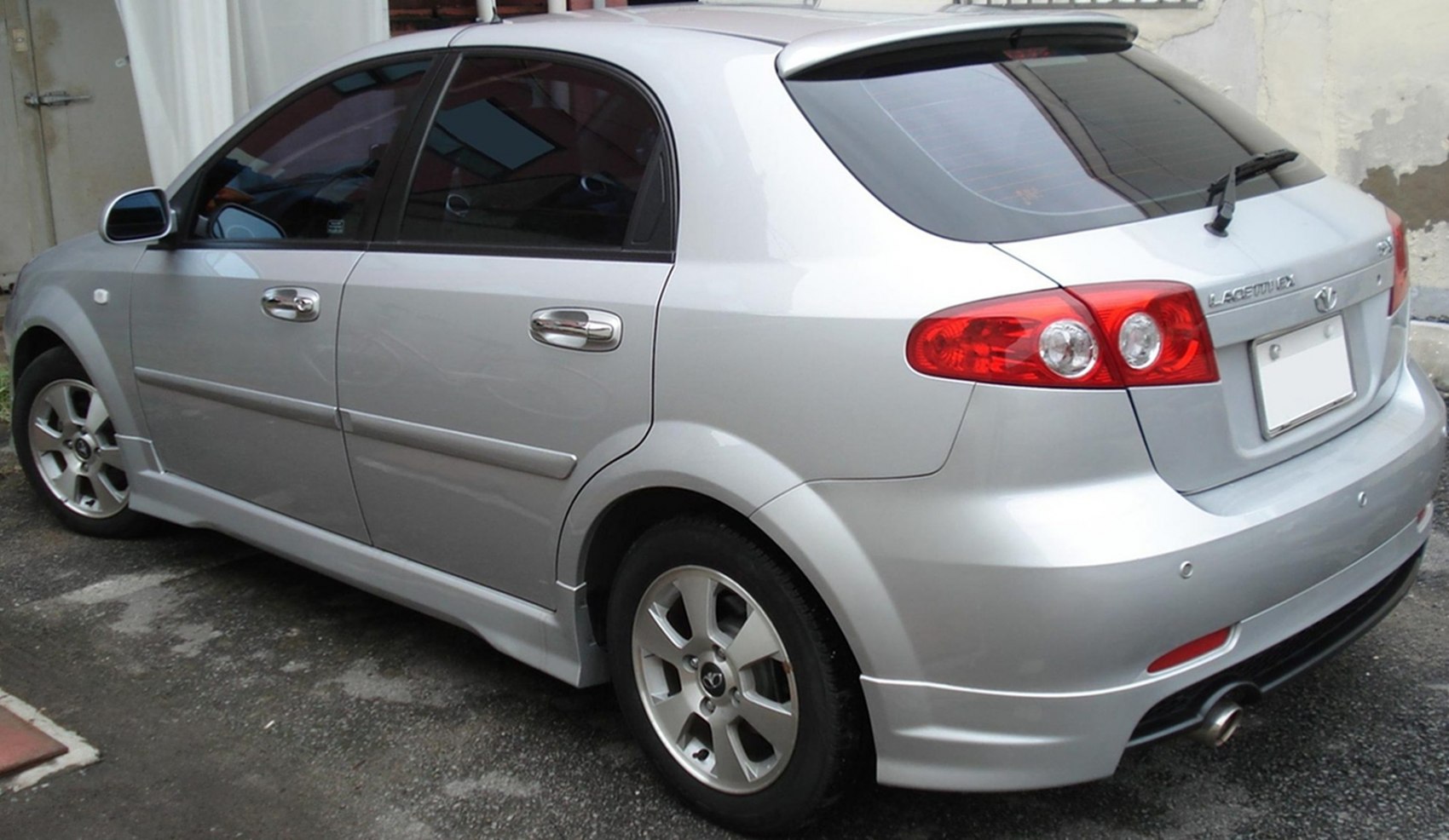 Silver 5-door hatchback with rear spoiler and alloy wheels