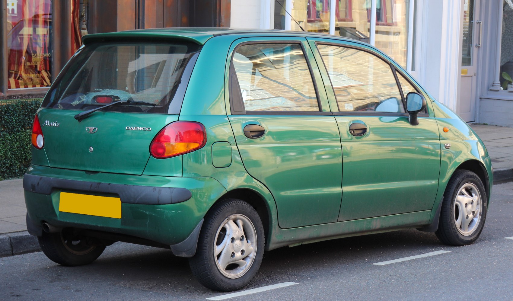 Compact hatchback rear quarter with rounded tail lights and door handles