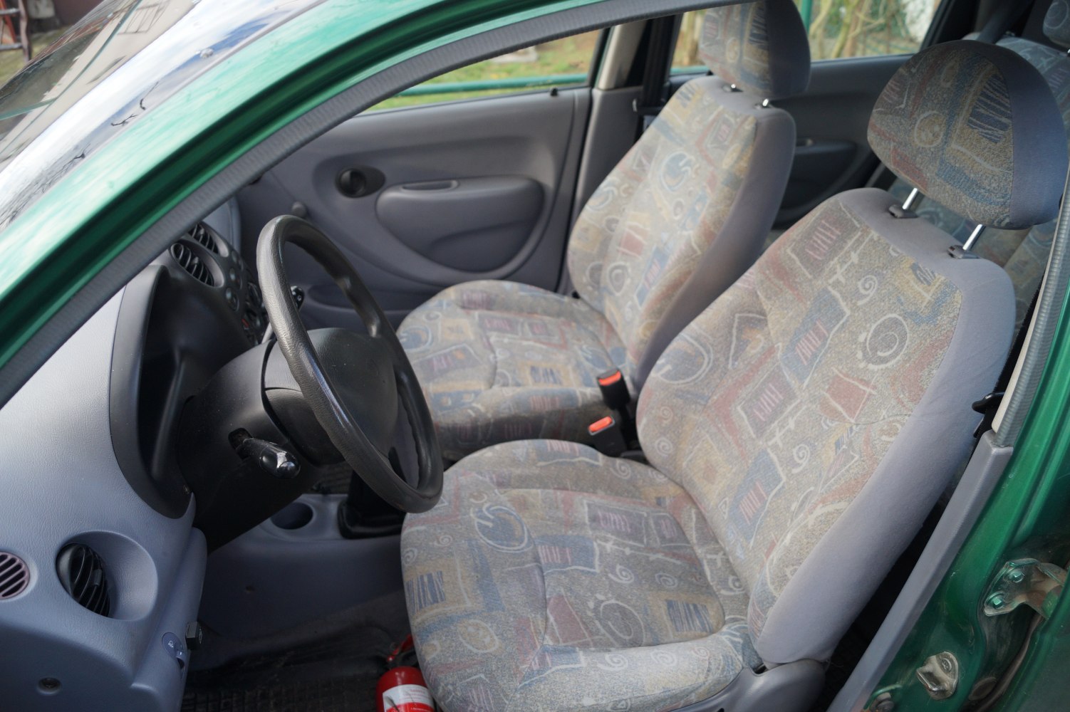 Vintage fabric upholstery seats and simple dashboard in compact car interior