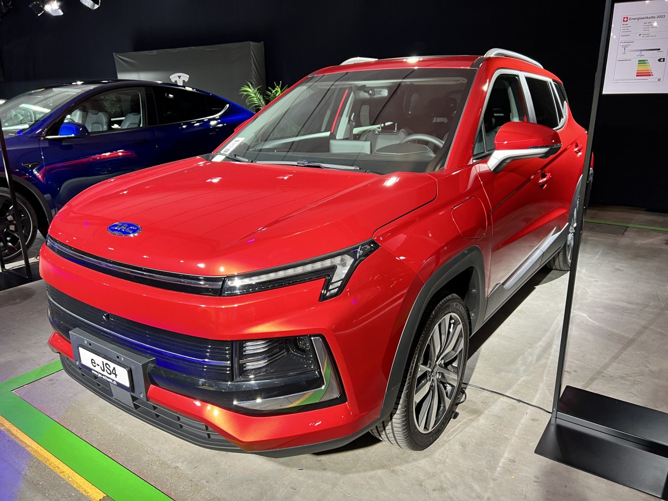 Red electric SUV with sleek LED headlights and aerodynamic front design
