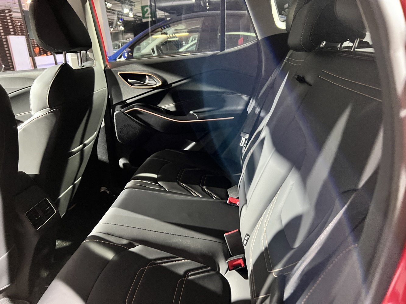Rear black leather seats and door panel design with stitching details