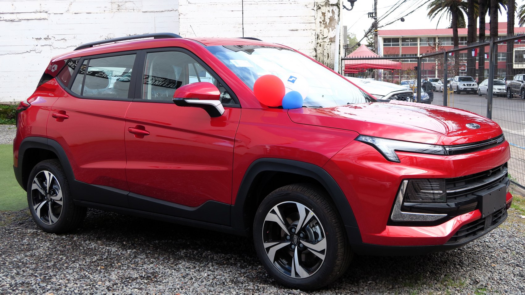 Red compact SUV with modern LED headlights and stylish alloy wheels