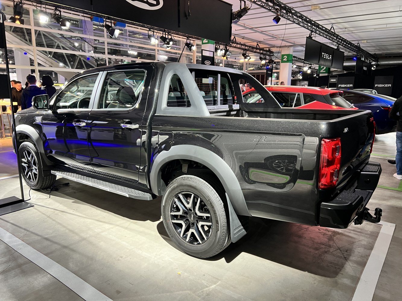 Black double cab pickup truck with rugged design and alloy wheels