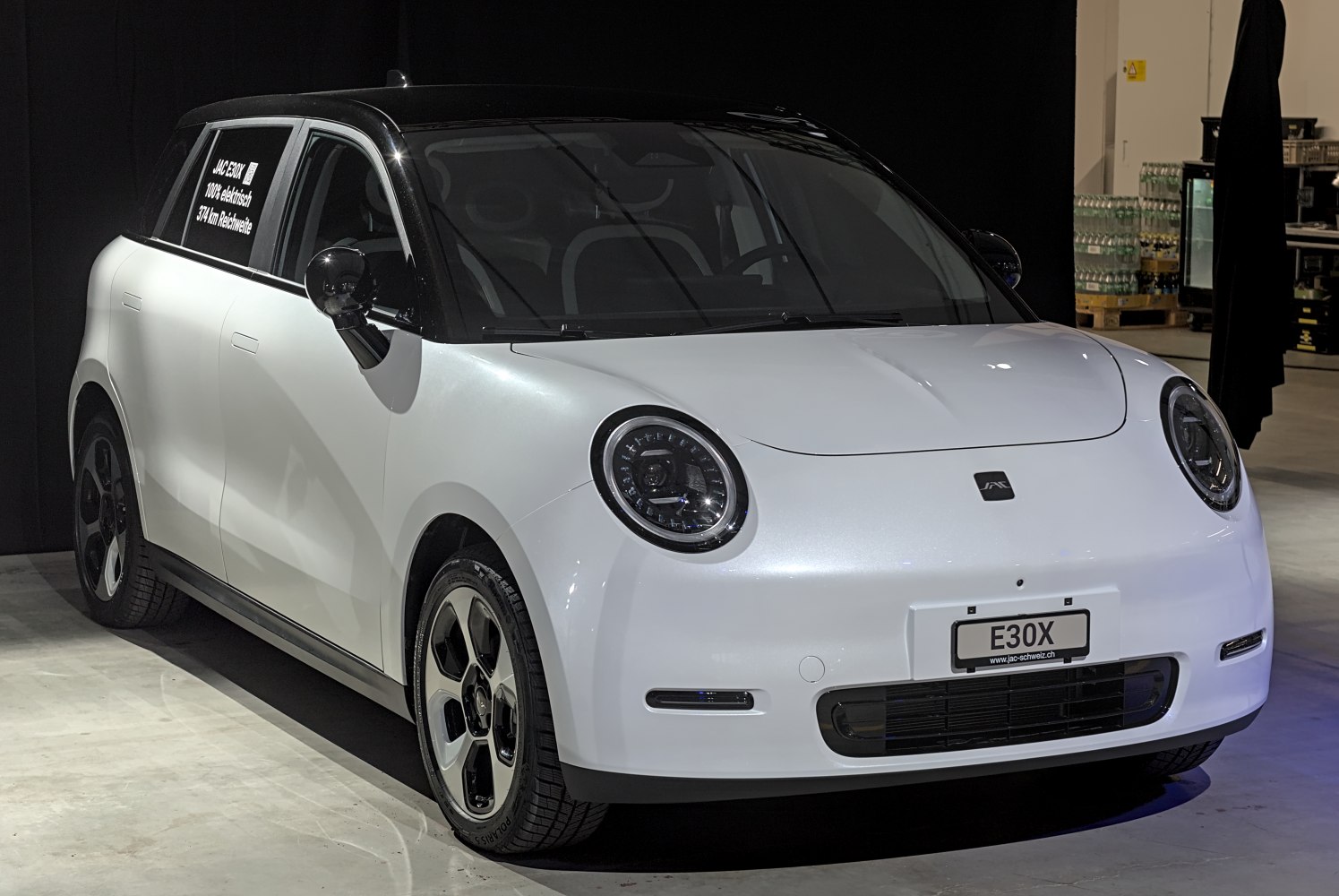 Front-side view with round LED headlights and two-tone paint.