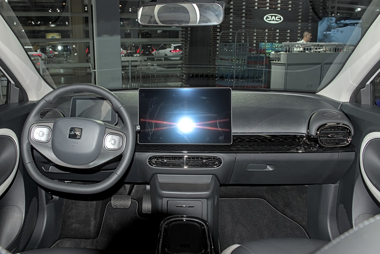 Modern dashboard with digital touchscreen and multifunction steering wheel.