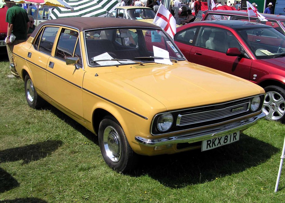 Yellow vintage sedan with rectangular grille and round headlights