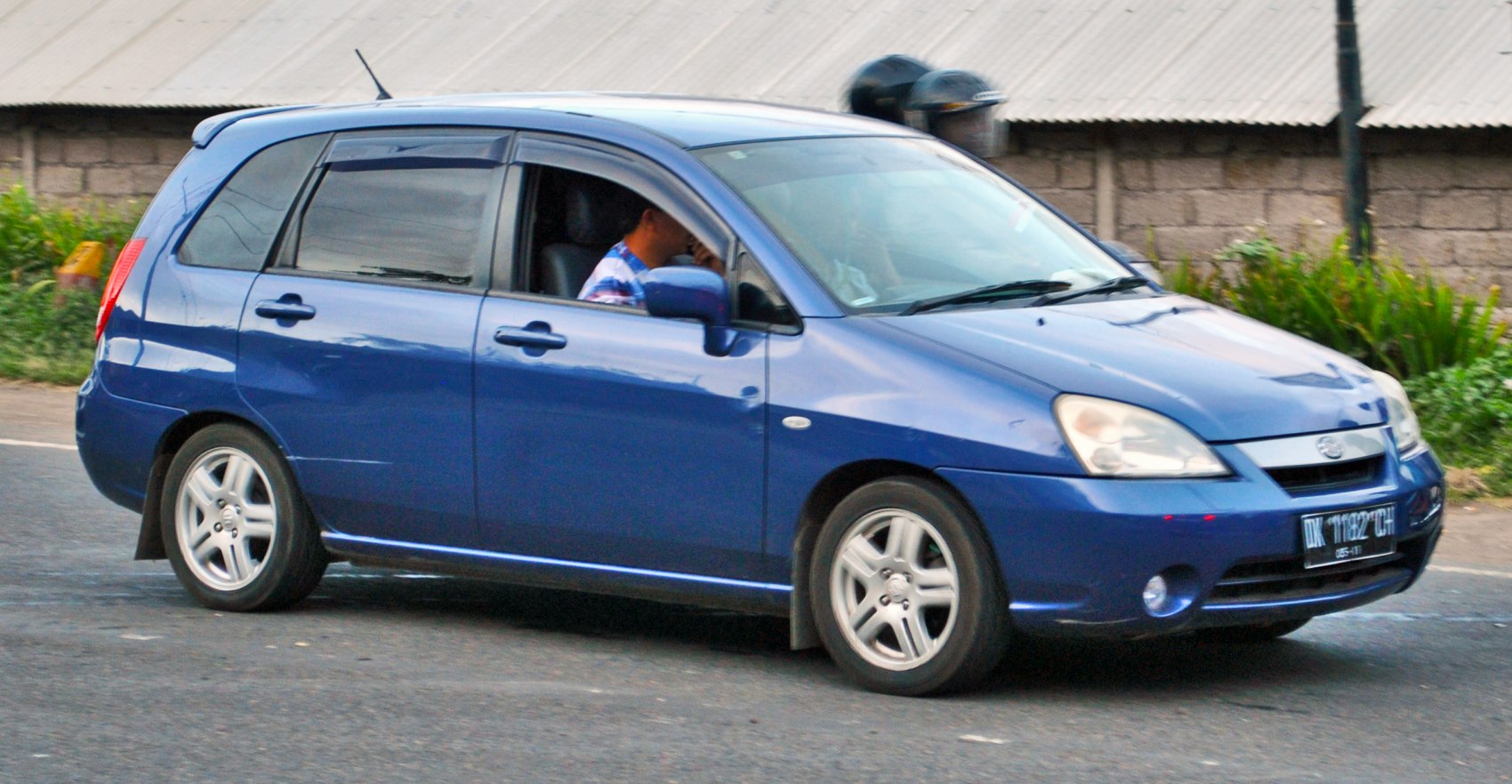 Blue hatchback with tinted windows and alloy wheels