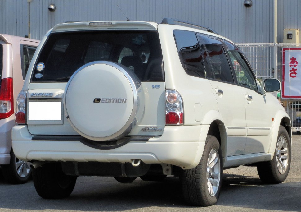 Rear view of SUV with rear-mounted spare tire and V6 badge