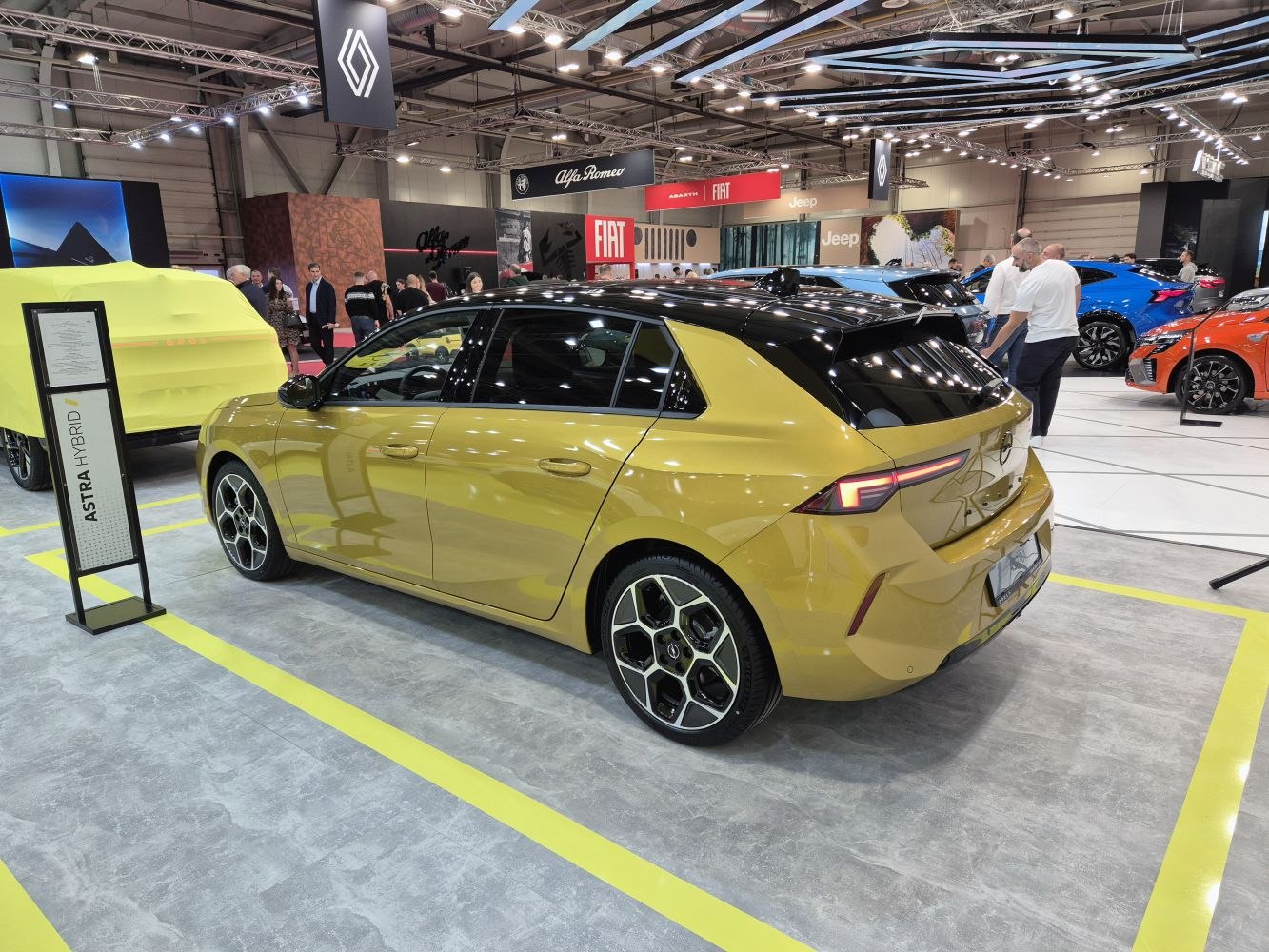 Rear side view of a modern hatchback with hybrid badge and distinctive LED tail lights