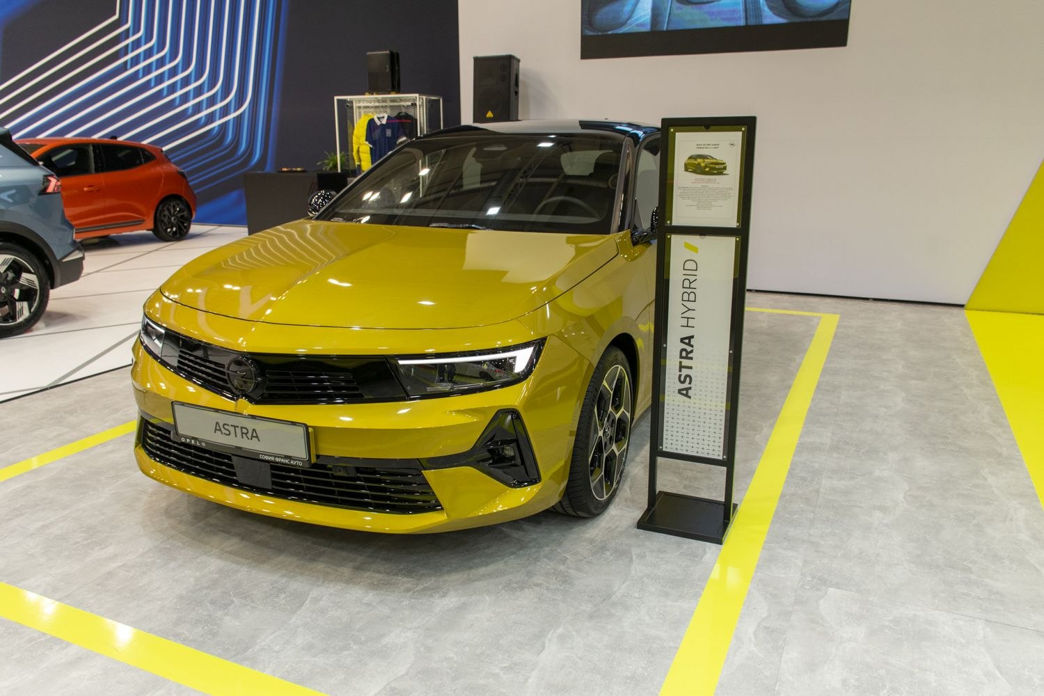 Front view of yellow hybrid car with black roof and LED headlights