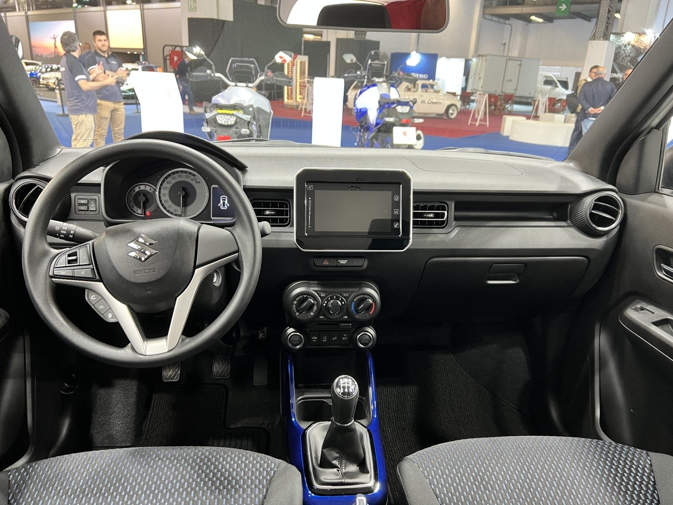 Compact interior dashboard with manual gear shift and touchscreen display.