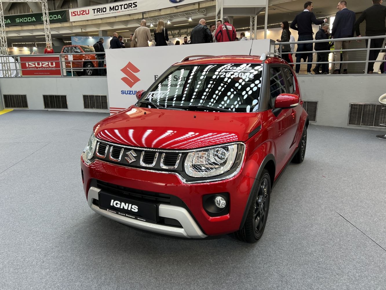 Red compact SUV with distinctive front grille and LED headlights