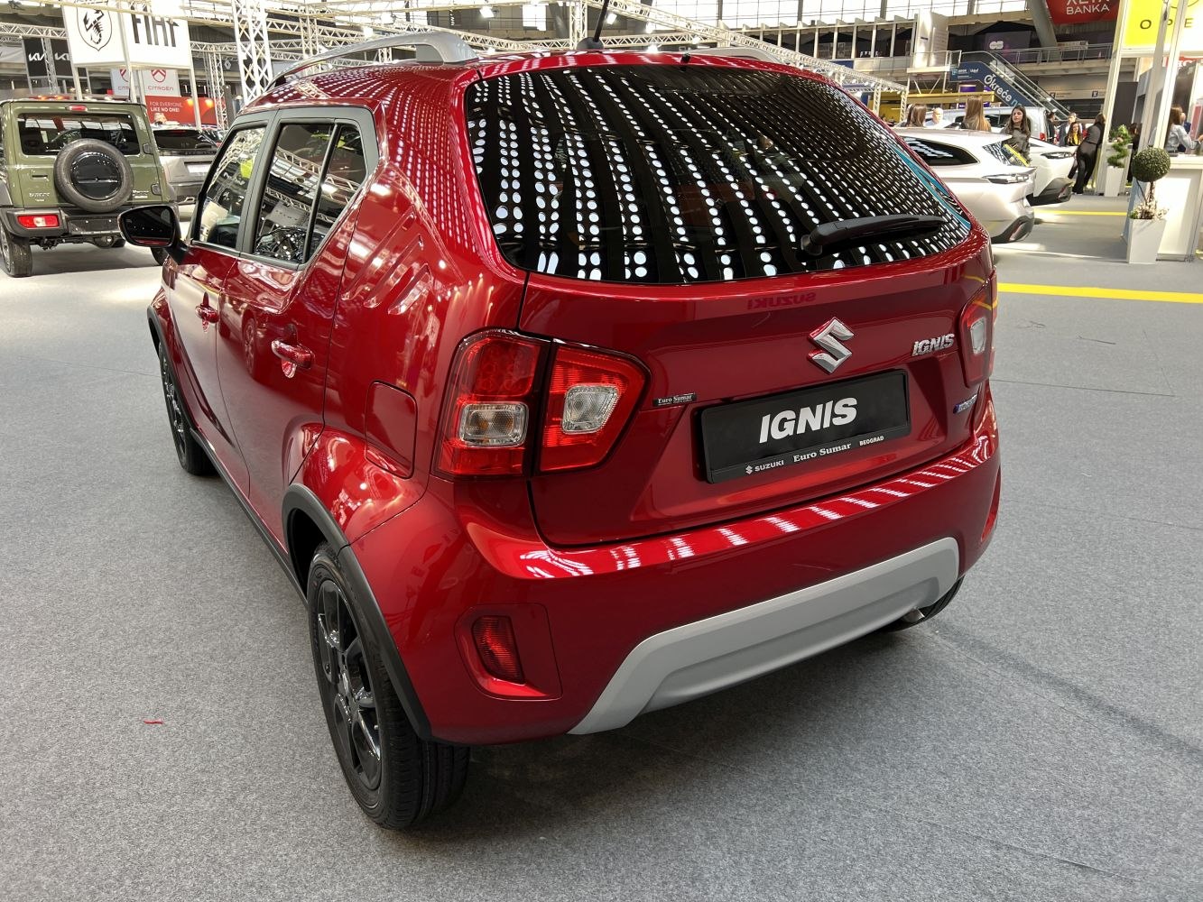 Rear view of red compact hatchback with distinct rear lights and black roof