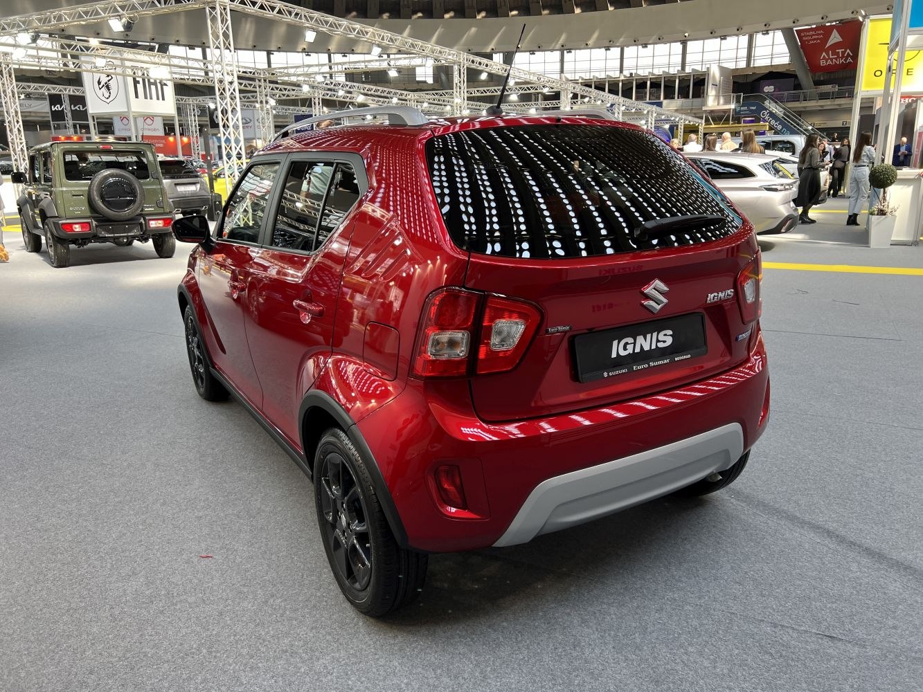 Red compact SUV hatchback rear and side view with black wheels.