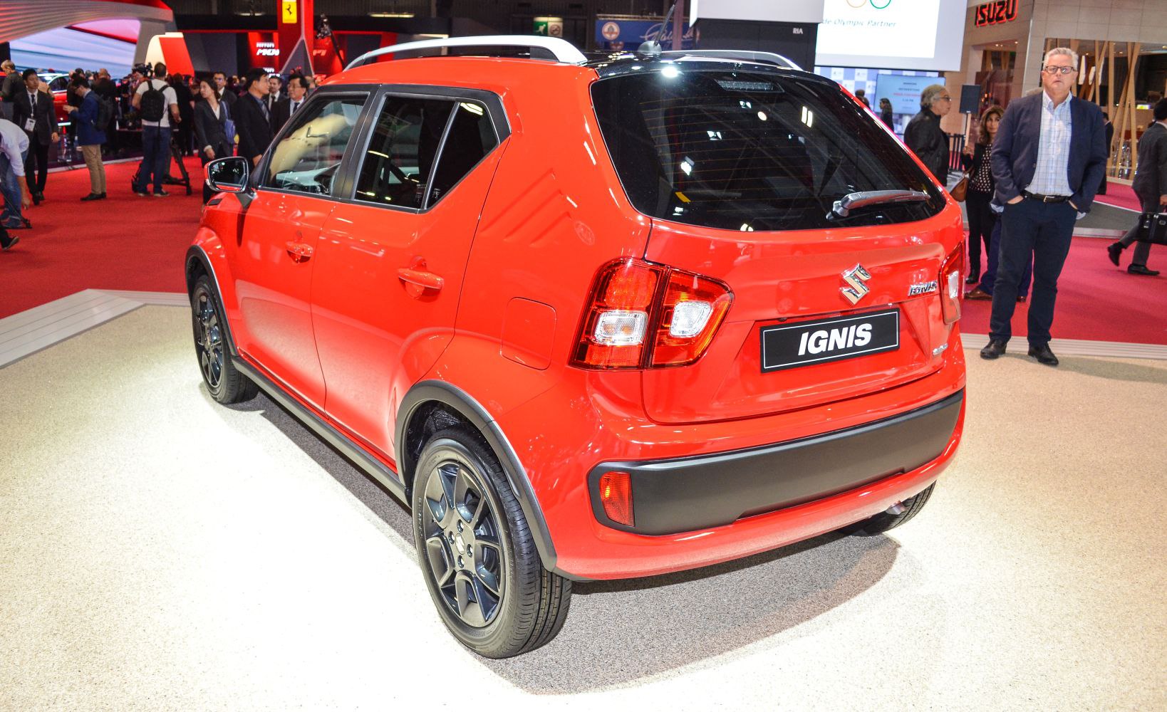 Red compact hatchback rear with black alloy wheels and modern taillights