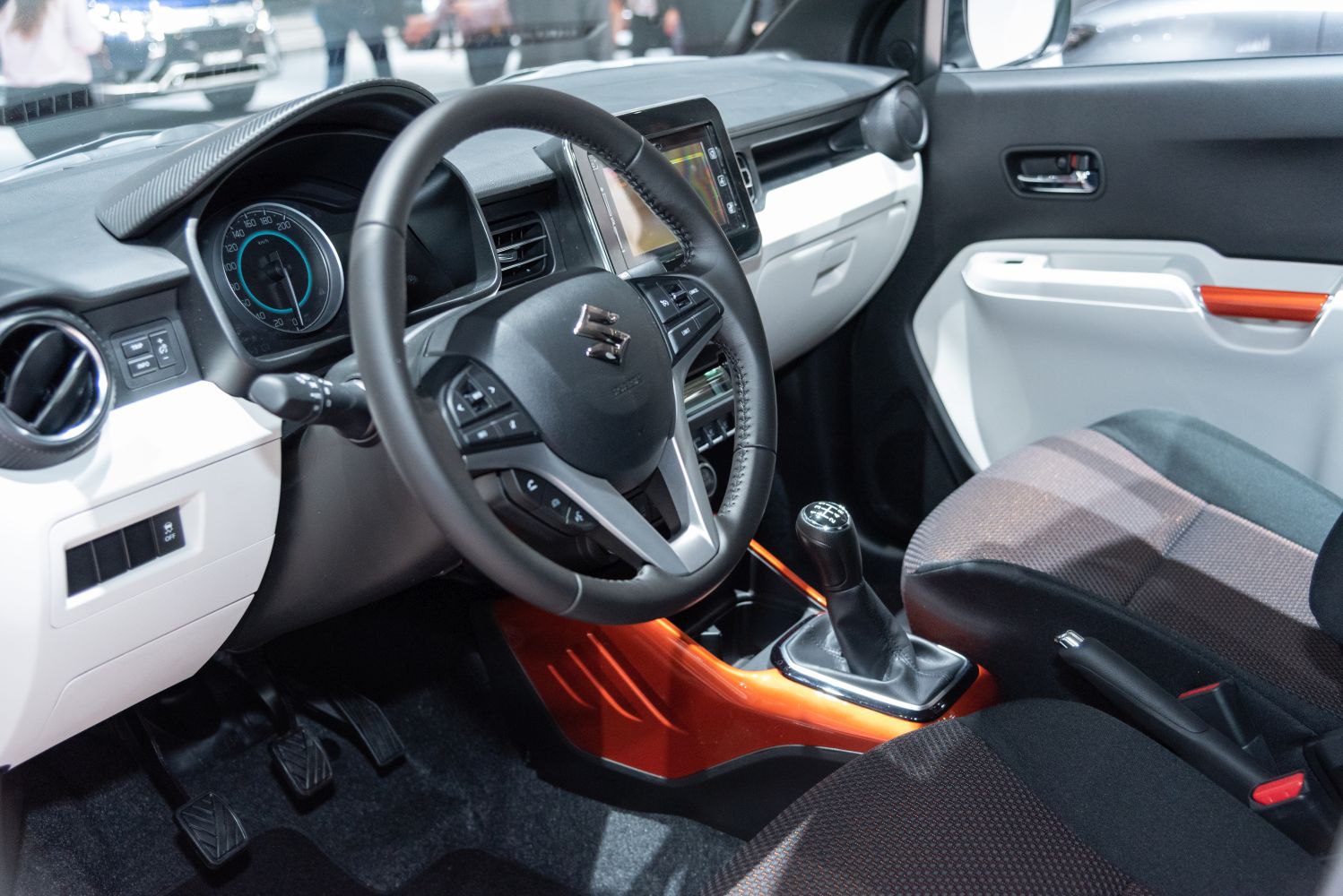 Steering wheel and manual gear shift interior close-up with dashboard and seats.