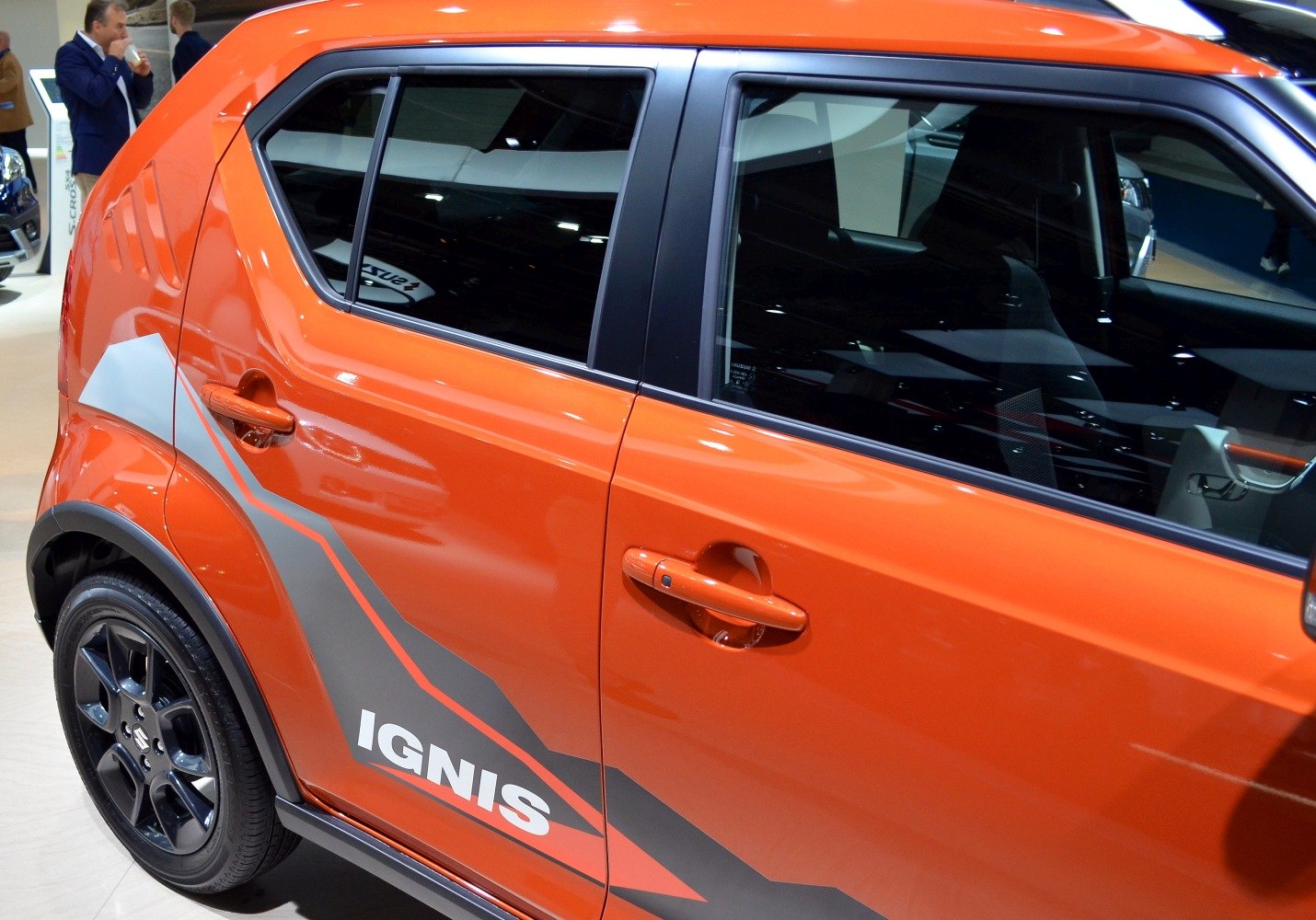 Close-up side view with unique decals on orange compact SUV
