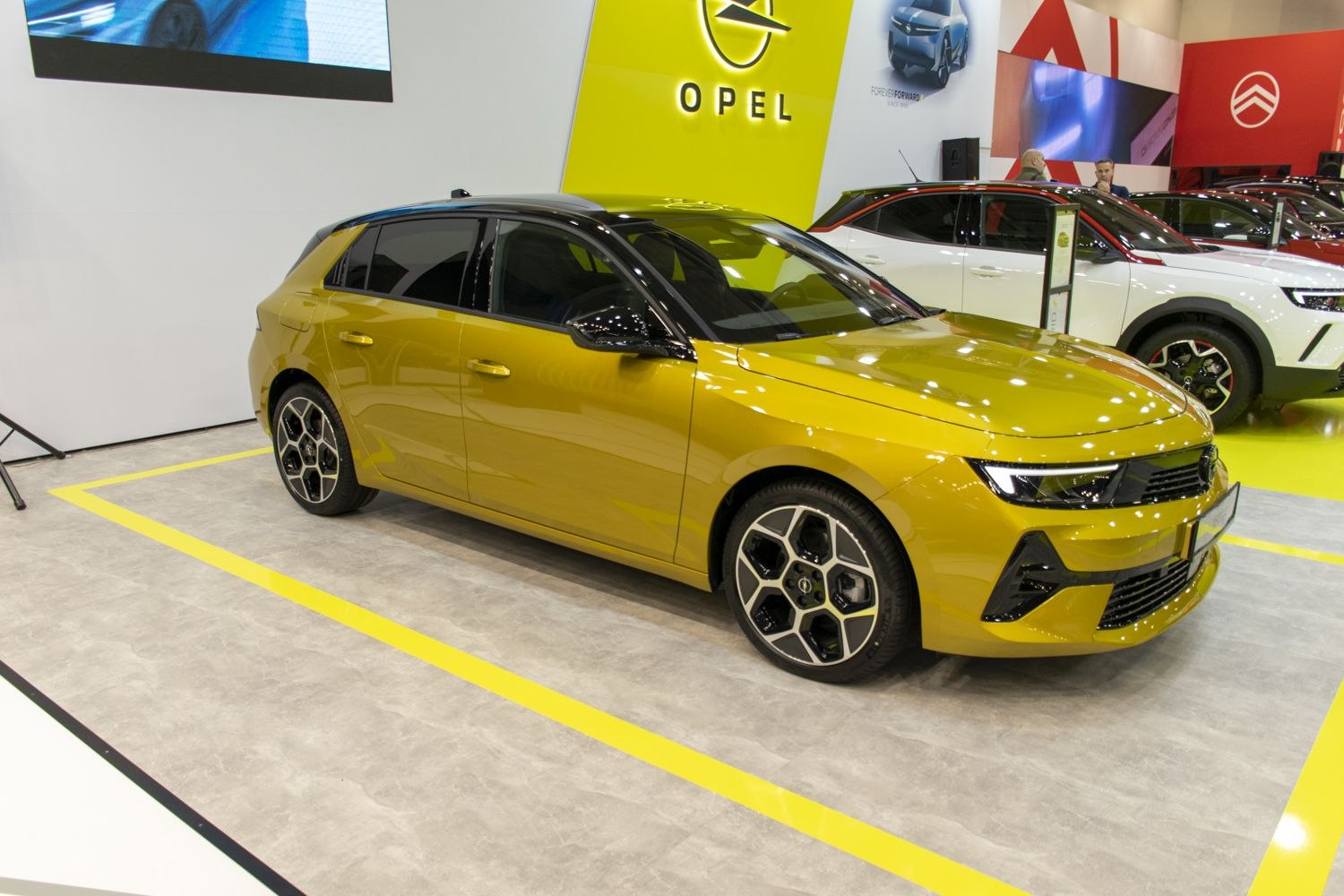 Modern hatchback with black roof and distinctive alloy wheels
