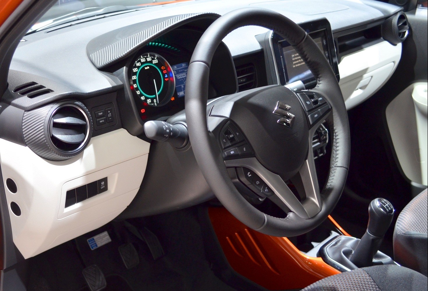 Steering wheel with controls, manual gear stick, and dashboard instruments