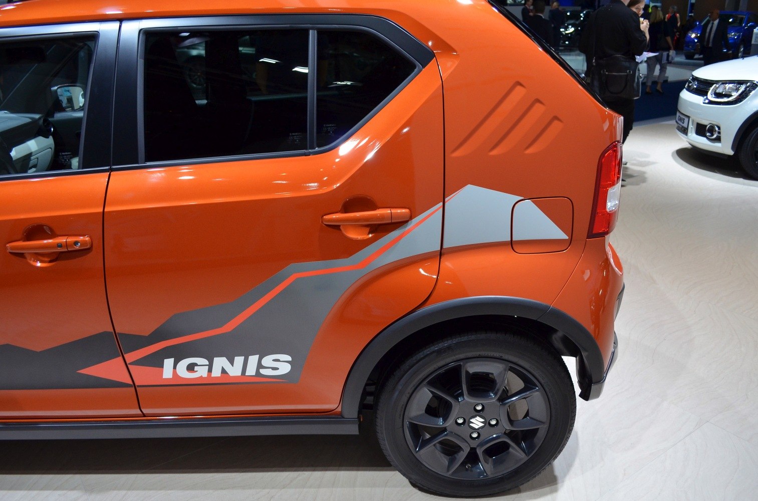 Side profile with bold decals and black alloy rear wheel