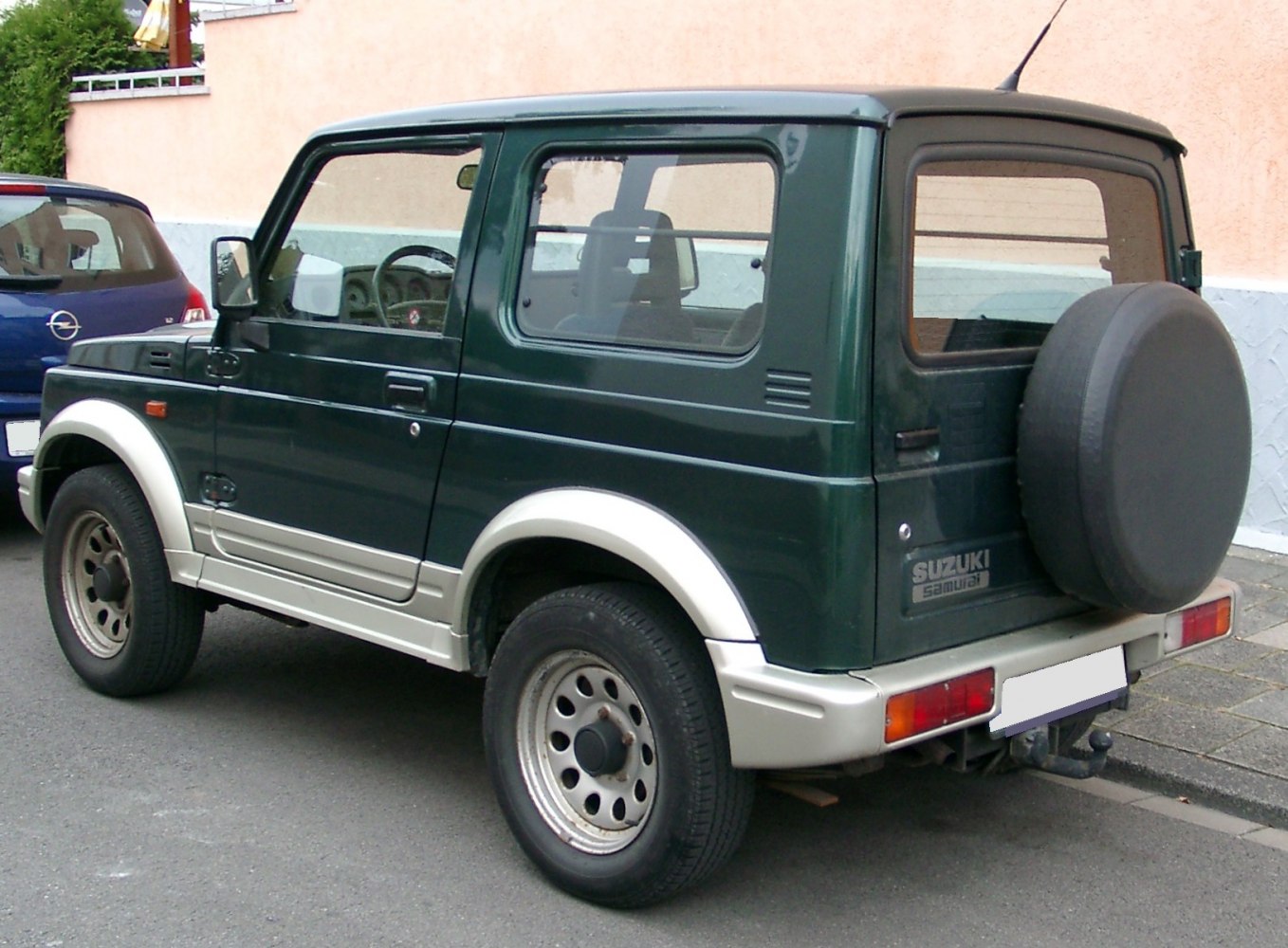 Compact off-road SUV rear side view with mounted spare wheel