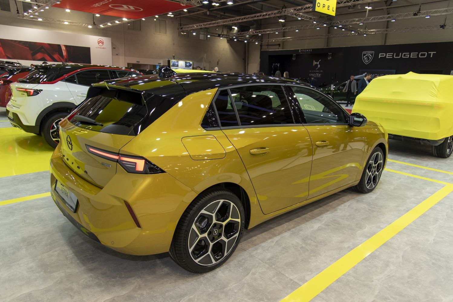 Aerodynamic roof spoiler and modern LED taillights on gold hatchback