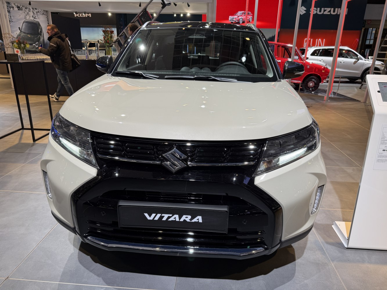 Front view with black grille, sleek headlights, and bold bumper design