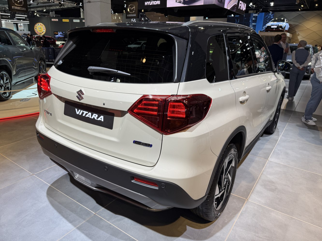 Rear view of hybrid SUV with black roof and distinctive tail lights
