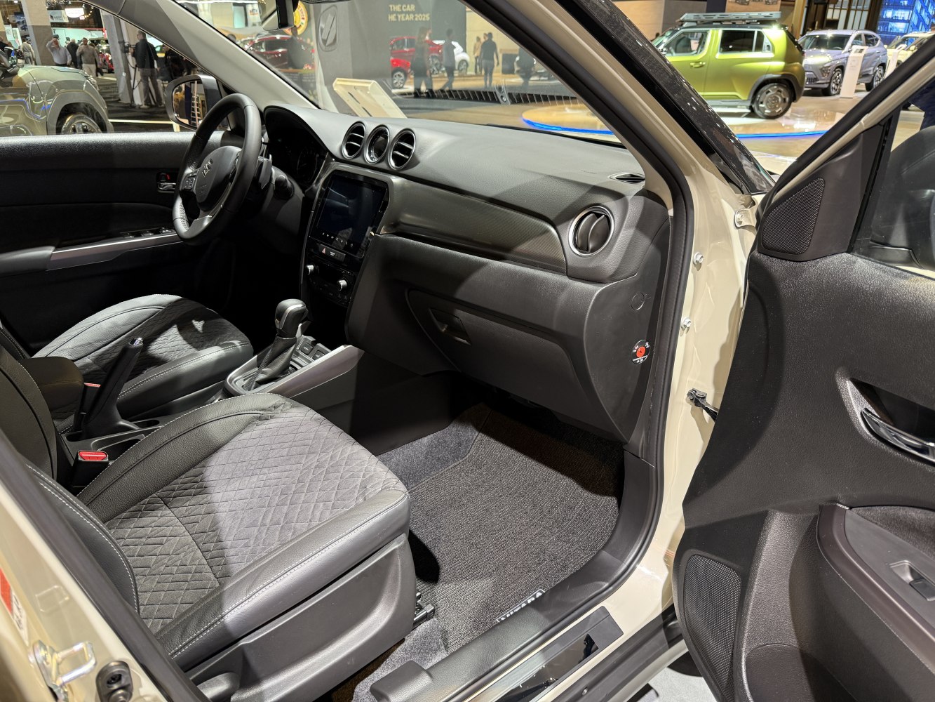 Modern car interior with quilted seats and central touchscreen panel