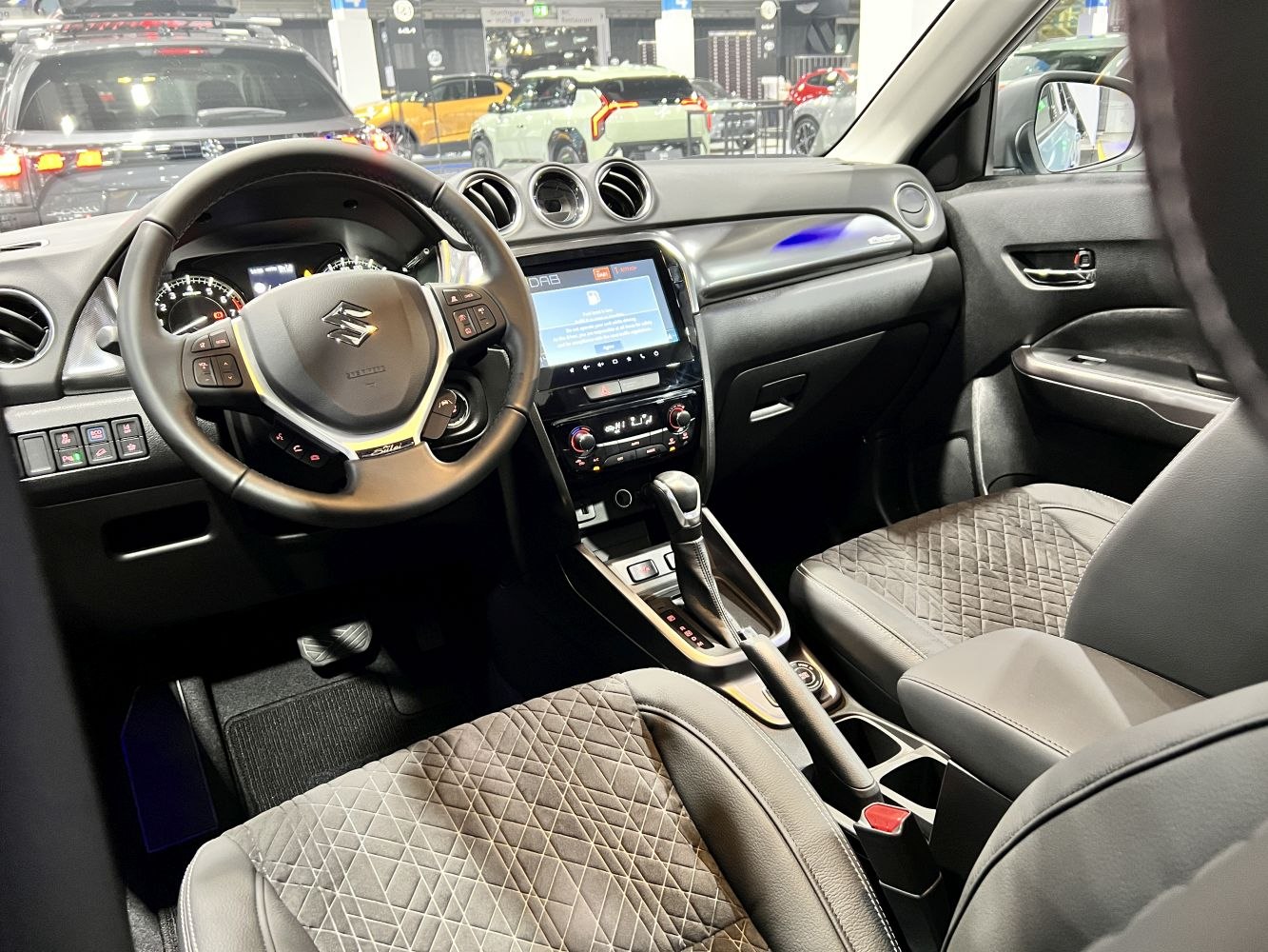 Modern car interior with touchscreen infotainment and multifunction steering wheel