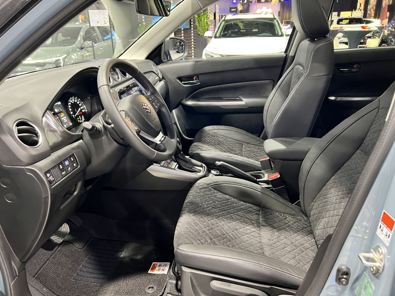 Modern interior with updated dashboard, steering wheel, and quilted seats
