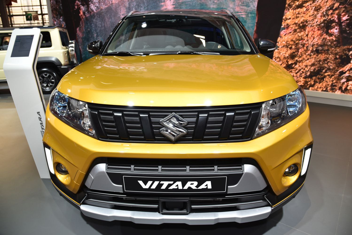 Front grille and headlight design of a yellow compact SUV.