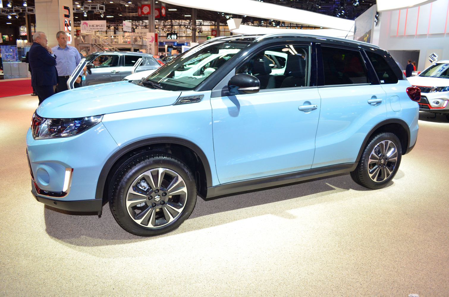 Side profile and alloy wheels of a modern compact SUV with distinct black roof.